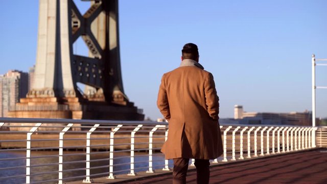 Asian Korean Man Walking Away At The Camden Waterfront Park In New Jersey, USA - Medium Shot