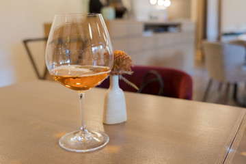 brandy, scotch or whiskey in a wine glass on a table at a restaurant scene
