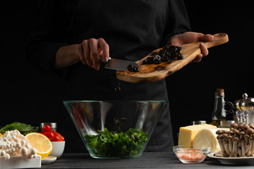 Healthy and wholesome food, preparing salad, spilling Italian olives. Useful and organic food. Gastronomy, grocery stores. Vegetarians and healthy diet. Freezing in motion, with space, advertising