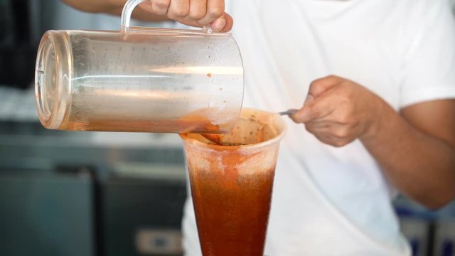 Thai tea maker, Men pouring tea into filter bags.