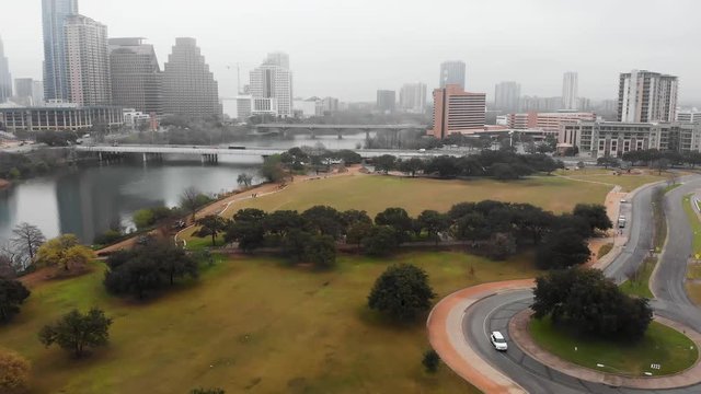 A drone captures images of lamar beach metro park at ladybird lake and the colorado river in downtown austin on a foggy day.