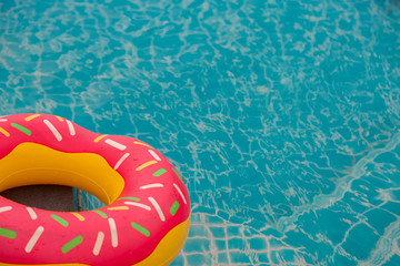 Rubber ring in blue swimming pool