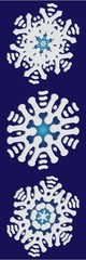 Set of isolated falling snowflakes on blue background.
