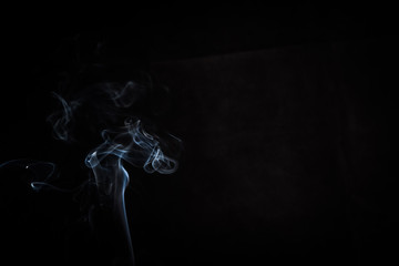 Abstract smoke swirls on black background