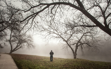 Brownwood Tx fog in the Riverside Park lake  winter season person 