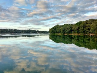 Fototapeta premium Trees reflected in the Salpeten Macanche Lagoon, Flores Peten, Guatemala