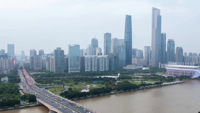 Guangzhou business city aerial cityscape China Pearl river with boats traffic and bridges timelapse pan up