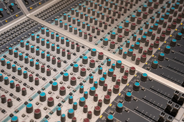 Close-up of the knobs of mixer in recording studio.