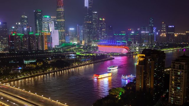 Guangzhou night business city aerial cityscape China Pearl river with boats traffic and bridges timelapse pan up