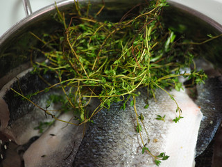 Fresh sea fishwith herbs being cooked