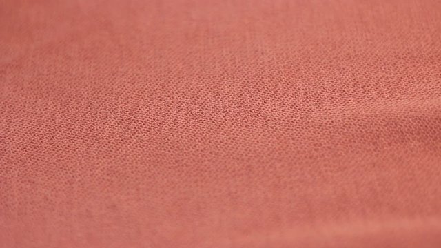 Knitted orange fabric movement trendy background.