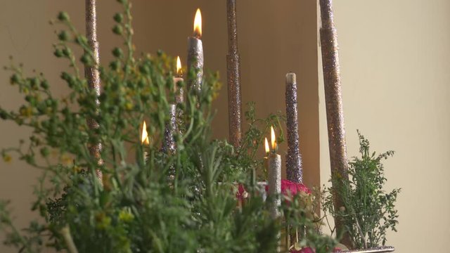 The candles is ready for a wedding day to be put in front of the groom while everyone is dancing in front of him