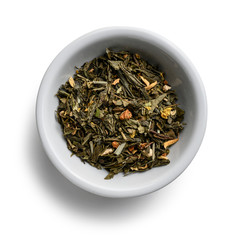 Green tea with aromatic additives. Top view on white background