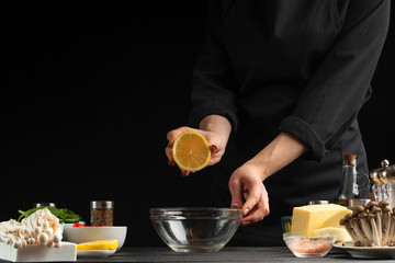 Freezing food prepares a vegetarian salad with seafood by the chef in the home kitchen. A concrete wall background with a text area for restaurant menu design.