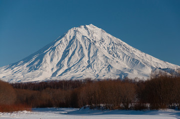Winter view of Kamchatka volcanoes full of snow.