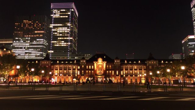 Tokyo railway station in the night with Tokyo skylines and traffic the road in the Marunouchi business district of Chiyoda, Tokyo, Japan.
