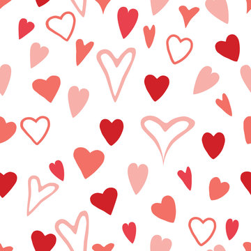 Seamless pink and red hand drawn hearts pattern design on white