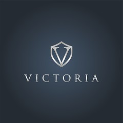 Initial v with shield metal metallic silver logo on a dark background