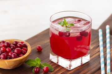 Red coctail with cranberry, vodka and ice. Refreshment drink.