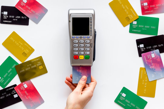 Payments in shops. Hand insert bank card in terminal on white background top-down