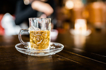 Chamomile tea welcome drinks served in small drinking glass with blur background. Herb drinks.