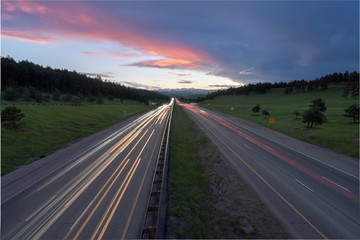 Car light trails with beautiful sunset over Buffalo Overlook at Genesee Colorado. Interstate-70 near Denver