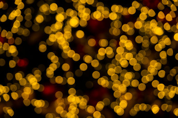 Defocused of blurred golden bokeh circle light from lighting bulb Merry Christmas and Happy New Year decorative in the night for abstract background texture