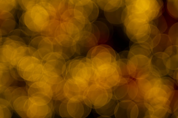 Defocused of blurred golden bokeh circle light from lighting bulb Merry Christmas and Happy New Year decorative in the night for abstract background texture