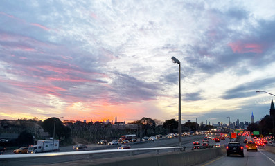 NEW YORK CITY - September 30th 2019. Sunset over the Manhattan skyline from Queens with traffic and cars.