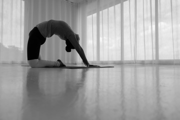 Asian woman practicing yoga in the white room, stretching in Ustrasana exercise, Camel pose, working out, ,Full length Concept of healing body and spirit,copy space