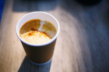 Hot coffee on a wooden background