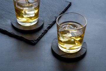 Scotch - two glasses with ice - on black background