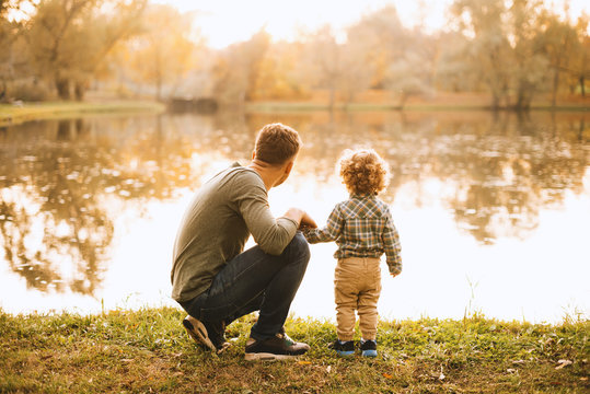 Photo of father and son having time together in park during autumn