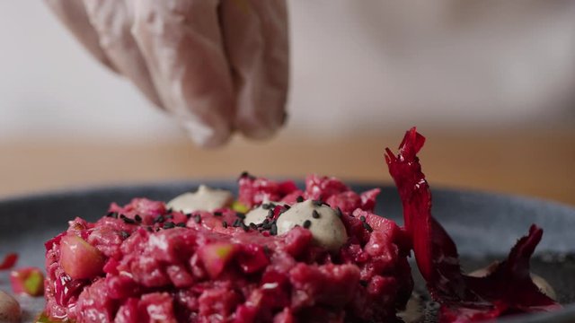 Seasoning beef Tar Tar with spices and pepper macro, five star meal, Michelin recipe,  slow motion, shot on Red Weapon Helium