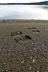 Only leave nothing but footsteps. Footsteps in black stony sand in western Canada