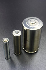set of batteries on black background