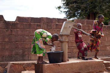Three Little African Girls Proud Of Successfully Pumping Water Out of a Village Borehole 