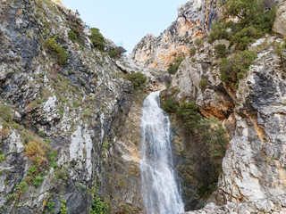 Fototapeta na wymiar Landscape of Provence. Waterfall of Riou from the cliff in Moustiers-Sainte-Marie