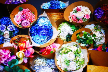 Fototapeta na wymiar Colorful fake flower bouquets in the market