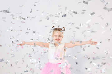 Party, holidays, birthday, new year and celebration concept - Cute child throwing confetti.