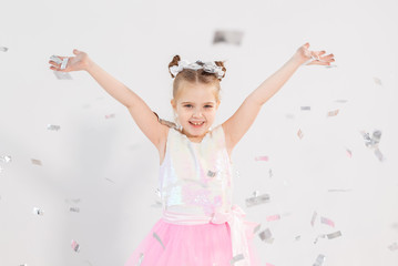 Party, holidays, birthday, new year and celebration concept - Cute child throwing confetti.