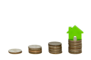 Isolated stacks of coin with house on white background
