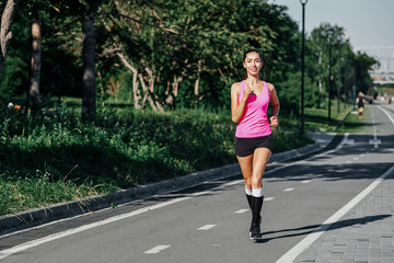 Running Woman on racetrack during training session. Female runner practicing on athletics race track