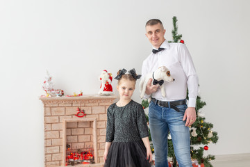 happy young father and his daughter at home with Christmas tree