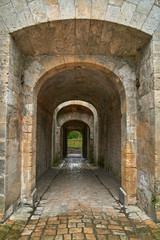 Fototapeta na wymiar passageway through fortress walls in bourg