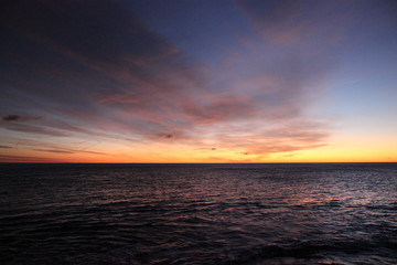 Obraz na płótnie Canvas Sunrise sea water clouds