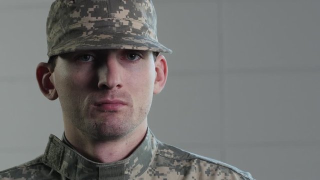 Soldier in camouflage and hat