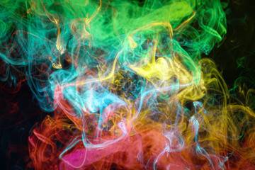 Pattern, Neon colorful smoke in the  on a dark isolated background. Background from the smoke of vape.
