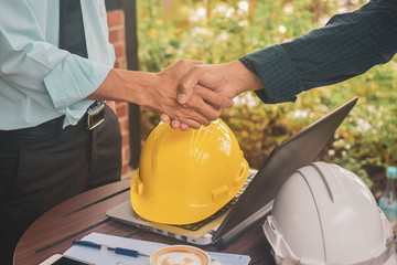 Engineering hands shake at work place building construction estate project success,Business people...