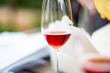 A close up of sparkling Rosé wine glass on a picnic table